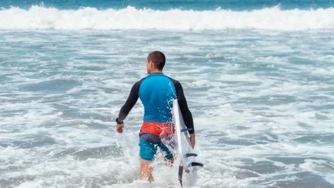 Guy goes surfing in the ocean Stock Illustration