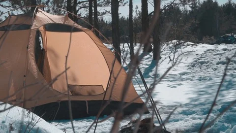 The guy goes to the tent in the winter forest Stock Footage