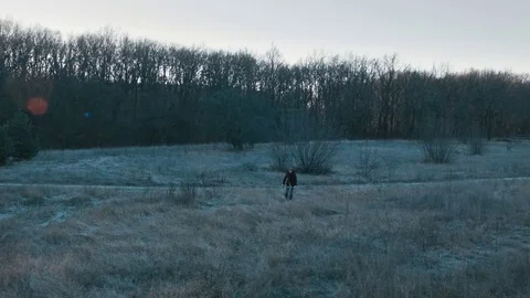 The guy goes through the forest with a torch Stock Footage 70765574