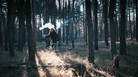 The guy goes through the forest with a torch Stock Footage 70765844