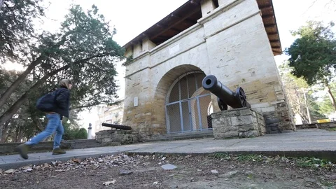 Guy going to old arch building with shadows. Male tourist. Stock Footage 99698672