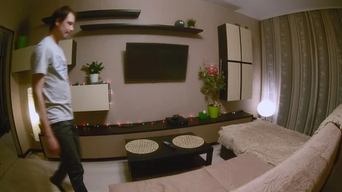 The guy is going to watch TV. General plan Stock Footage 87403713