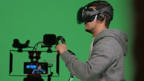 Guy in a green screen box at public virtual reality event Stock Footage 83203475