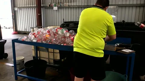 Guy in green shirt counting bottles Stock Footage