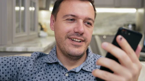Guy greeting and talking by video conference via mobile application. Smiling Stock Footage 169944922