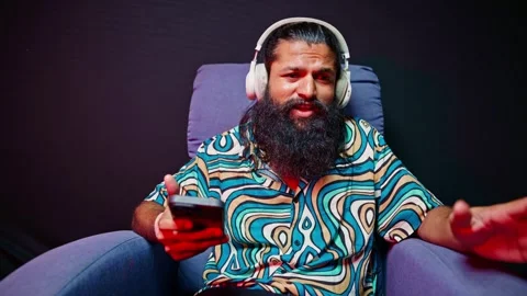 Guy grooving to beat while holding his phone Stock Footage 296530586