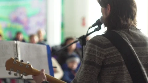 The guy with the guitar singing at the microphone Stock Footage 108896584