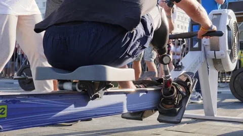 Guy handicapped with prosthetic feet in comfortable shoes pulls cable close-up Video stock 83431049
