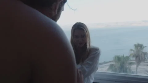 Guy hands over bottle of champagne to lover on floor Stock Footage 275748540