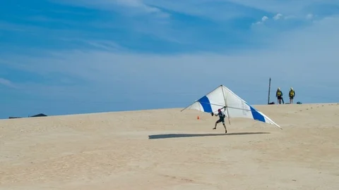 Guy Hang Gliding on Sand Dune at Jockeys Ridge in Outer Banks NC Stock Footage 73027267