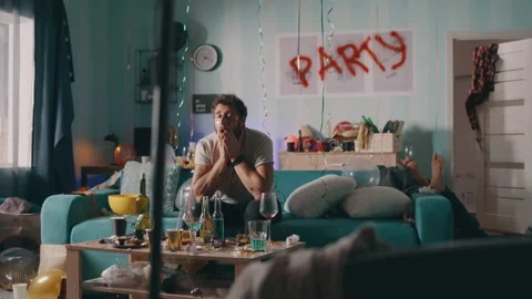 Guy with hangover sitting on sofa Stock Footage 162755066