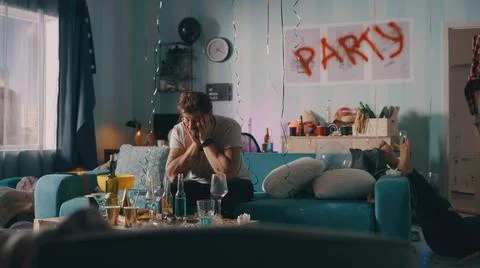 Guy with hangover sitting on sofa Stock Photos