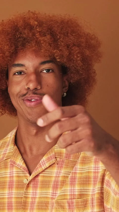 Guy happily winking pointing with finger and looking at camera, isolated on Stock Footage 259627834