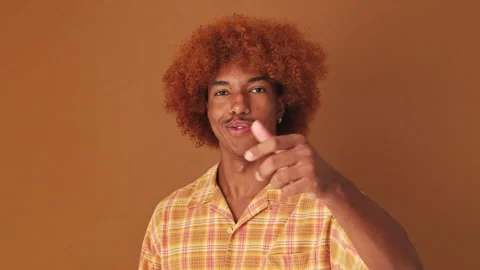 Guy happily winking pointing with finger and looking at camera, isolated on Stock Footage 259627897