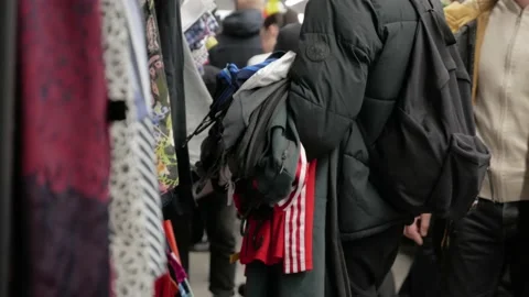 The guy has a lot of clothes in his hands in store: Gomel, Belarus - Feb 2020 Stock Footage 142734427
