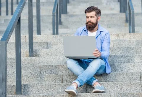 Guy has online video computer communication outdoor. guy has online video Stock Photos