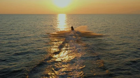 A guy have a fun with his watercraft at sunset silhouette Stock-Footage 126592020