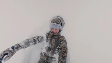 The guy is having fun falling into the snow with his back. Stock Footage 327716988