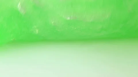 The guy is having fun with a toy slime with his fingers pressing on the slime Stock Footage 250522347