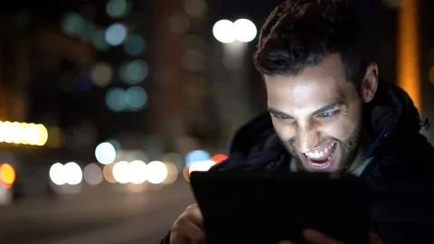 Guy Having Good News on tablet Stock Footage 89729712