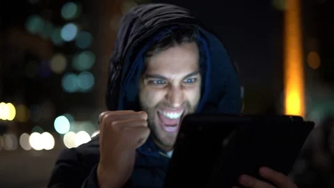 Guy Having Good News on tablet Stock Footage 89729839