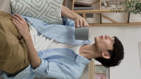 Guy having tea and looking away Stock Footage 230206808