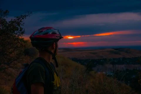 Guy in a helmet at sunset Stock-Fotos