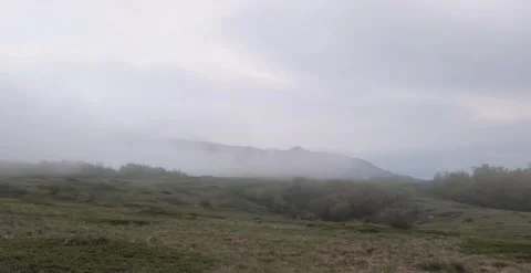 Guy on a hike. Man puts up a tent. fog in the mountains Stock Footage 166399048
