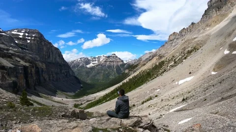 Guy hiker is drinking water from a bottle at Stanley Glacier Stock Footage 148889662