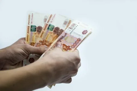 A guy in his hands counts 5 thousandth banknotes of Russia. Stock Photos