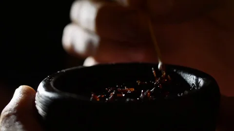 The guy with his hands pulls the tobacco in the bowl for the hookah. Preparation Stock Footage 87779269