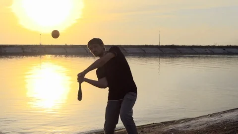 Guy hit a fruit bat slow motion. Man break vegetable piece. Baseball slowmotion. Stock Footage 72548549