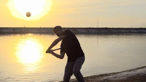 Guy hit a fruit bat slow motion. Man break vegetable piece. Baseball slowmotion. Stock Footage 72548724
