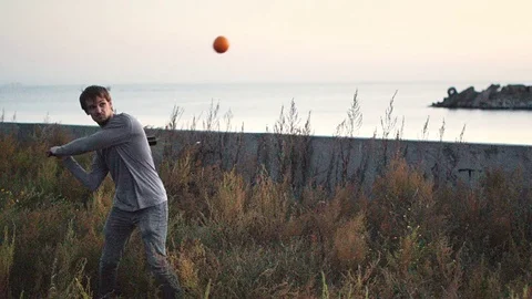 Guy hit a fruit bat slow motion. Man break vegetable piece. Baseball slowmotion. Stock Footage 72549285