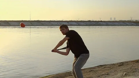 Guy hit a fruit bat slow motion. Man break vegetable piece. Baseball slowmotion. 스톡 동영상 72550468