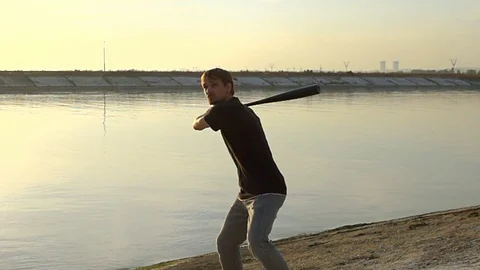 Guy hit a fruit bat slow motion. Man break vegetable piece. Baseball slowmotion. Stock Footage 72550550