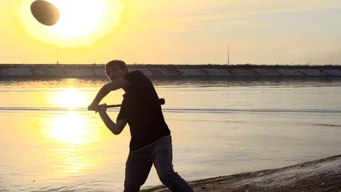 Guy hit a fruit bat slow motion. Man break vegetable piece. Baseball slowmotion. Video stock 72554316