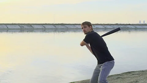 Guy hit a fruit bat slow motion. Man break vegetable piece. Baseball slowmotion. Stock Footage 72558401