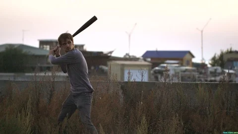 Guy hit a fruit bat slow motion. Man break vegetable piece. Baseball slowmotion. Stock Footage 72558959