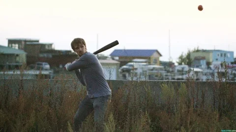 Guy hit a fruit bat slow motion. Man break vegetable piece. Baseball slowmotion. Stock Footage 72560266