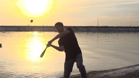 Guy hit a fruit bat slow motion. Man break vegetable piece. Baseball slowmotion. 스톡 동영상 72560721