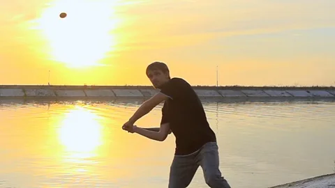 Guy hit a fruit bat slow motion. Man break vegetable piece. Baseball slowmotion. Stock Footage 72561041