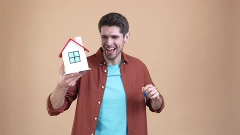 Guy hold building key achieve lottery win isolated pastel color background Video stock 169937373