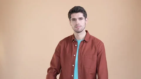 Guy hold hand camera not way ignore isolated pastel color background Video stock 169936912