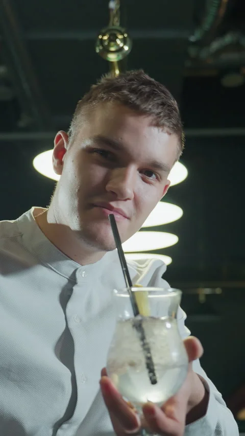 Guy Holding Cue Stick and Lemon Drink Taking Sip in Stylish Pool Hall Stock Footage 319798805