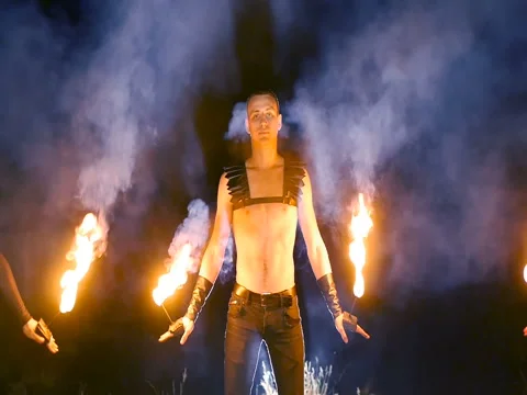 The guy holding the fire in the dark, It emits smoke Stock Footage 71495294