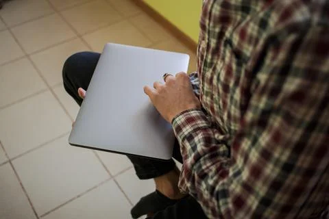 The guy is holding a laptop for work Stock Photos