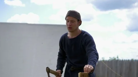 Guy is holding a log in his hands and talking to someone Stock Footage 82402355