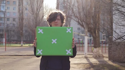 Guy holding a picket poster, poster with a green background for text, single  Stock Footage 125911298