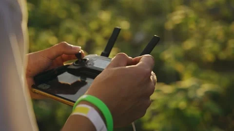 The guy is holding a quadcopter control panel in his hands Stock Footage 170585959